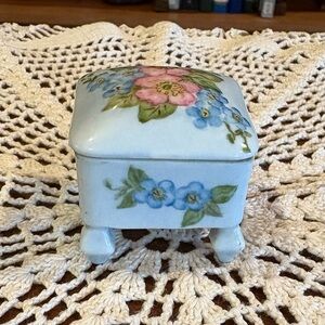Vintage hand-painted porcelain trinket box with a floral motif